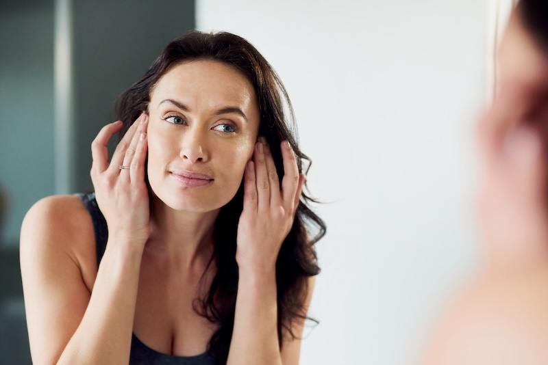 woman touching face near ear